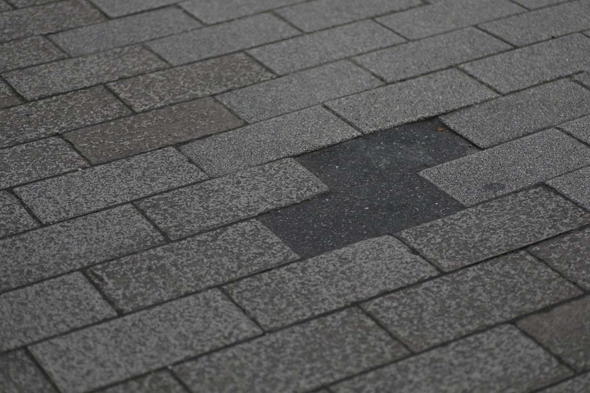 Storm damage visible on roofing shingles